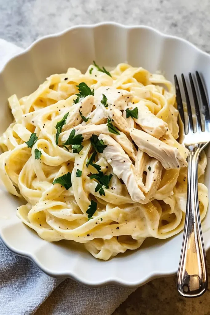what to do with leftover rotisserie chicken 8 Plate of creamy fettuccine Alfredo topped with shredded rotisserie chicken and parsley