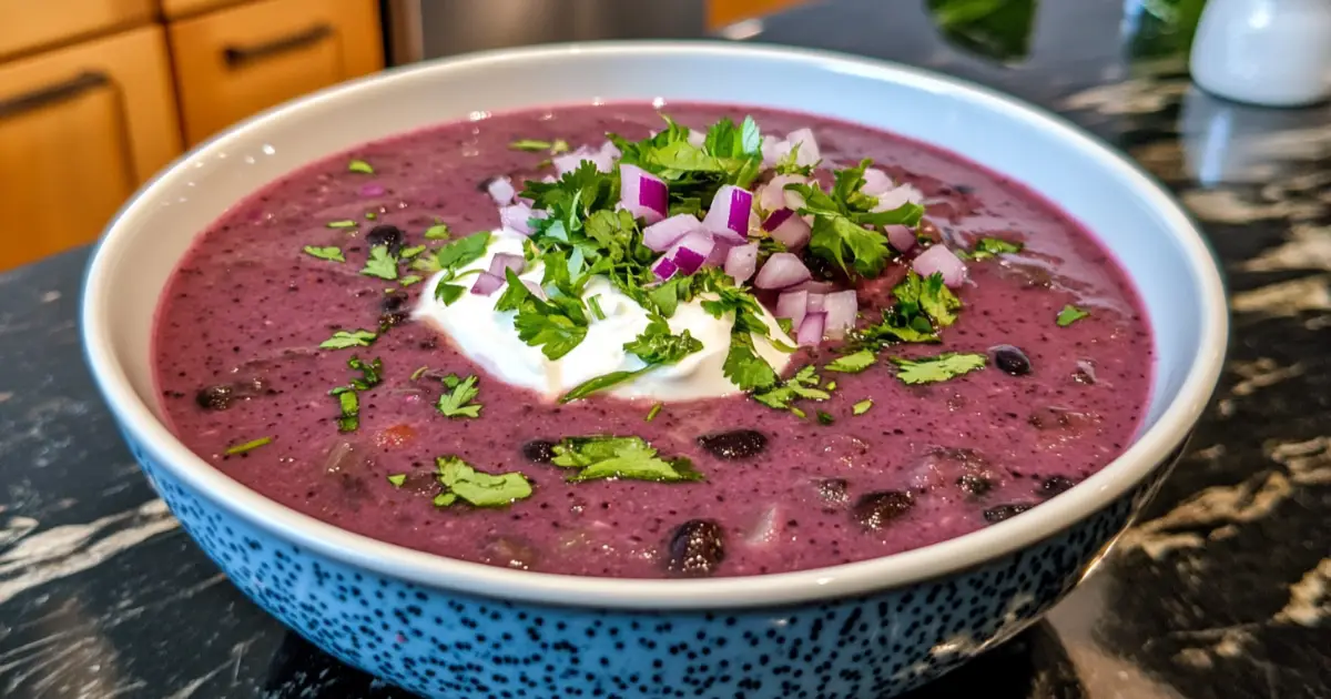 Bowl of Vibrant Purple Black Bean Soup with Garnishes