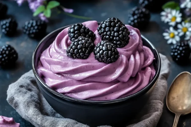 Blackberry Mousse Recipe 2 Glass cup filled with creamy blackberry mousse topped with fresh berries and mint leaves