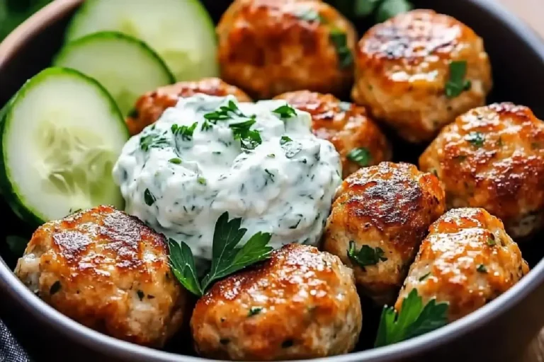 Greek Chicken Meatballs 2 Tender baked Greek chicken meatballs with herbs, lemon, and feta, served with tzatziki and pita.